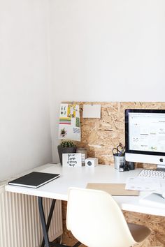 a white desk topped with a computer monitor and keyboard