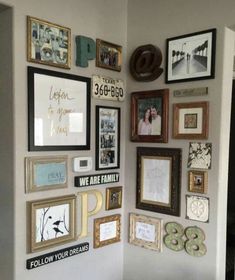 a wall filled with lots of framed photos and pictures on it's sidewall