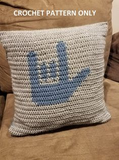 a crocheted pillow sitting on top of a couch