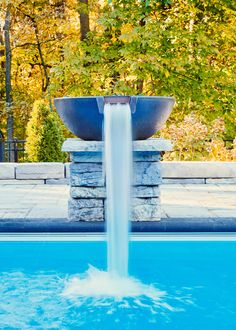 a large blue bowl sitting on top of a swimming pool