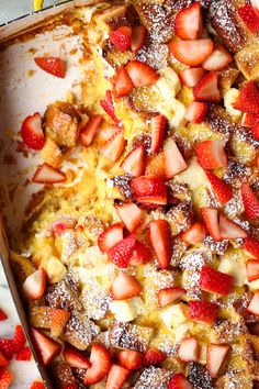 a pan filled with french toast covered in strawberries