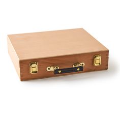 a wooden box with two brass handles and latches on the front, sitting on a white surface