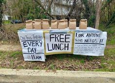 several signs are displayed on the grass outside