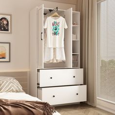 a bedroom with a bed, dresser and white wardrobe in it's corner next to a window