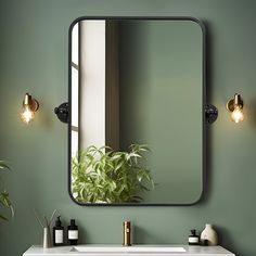 a bathroom sink with a mirror above it and lights on the wall next to it