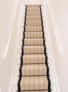 a carpeted staircase leading up to the second floor