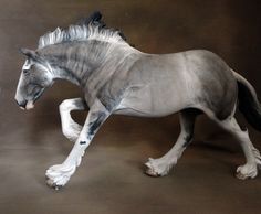 a grey horse with white mane and tail is galloping in front of a black background