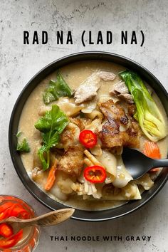 a bowl filled with noodles, meat and veggies on top of a table