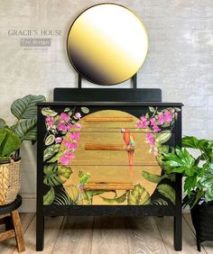 a mirror sitting on top of a wooden cabinet next to plants and potted plants