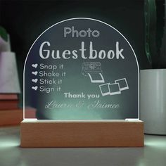 a clear glass plaque with the words photo guestbook on it