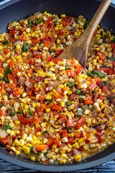 a skillet filled with corn and vegetables