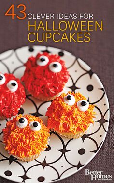 three cupcakes decorated with red icing and googly eyes on a plate