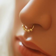 a close up view of a nose with a ring on it