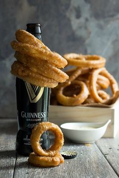 a bottle of guinness and some onion rings