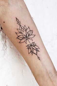 a woman's arm with a tattoo on it that has a flower in the middle