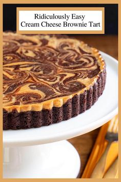 a brownie tart is sitting on a white plate