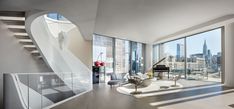 a living room filled with furniture and tall buildings