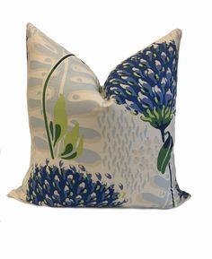 a blue and white pillow with flowers on it