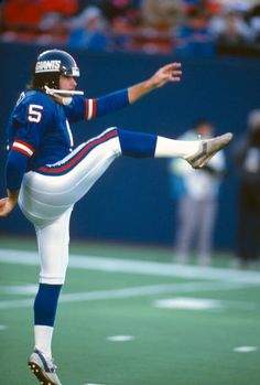 a football player is doing a kick on the field with his leg in the air