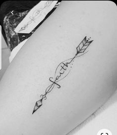 a woman's thigh with an arrow tattoo on it