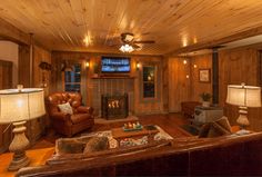 a living room filled with furniture and a flat screen tv mounted to the wall next to a fire place