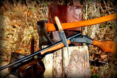 an assortment of woodworking tools sitting on top of a tree stump