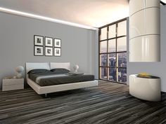 a modern bedroom with wood flooring and gray walls