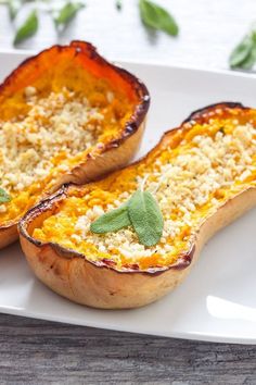 two baked dishes on a white plate with green leafy garnish and parmesan cheese