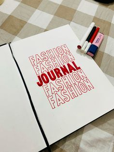 an open book with the words fashion, fashion journal written in red on it and crayons next to it