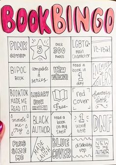 a hand holding up a sign that says bookbingo with pink writing on it