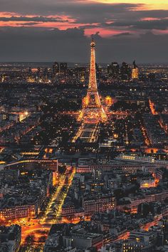 the eiffel tower lit up at night in paris, france as seen from above