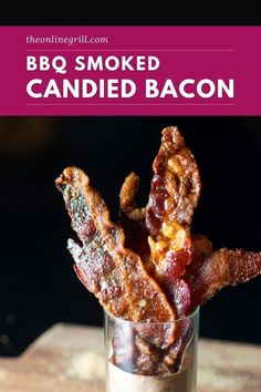 bacon is in a small glass on a wooden table with the words bbq smoked candied bacon