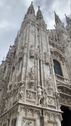 an ornate building with statues on the front