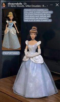 the doll is wearing a blue dress with white trims and an elaborate tiara