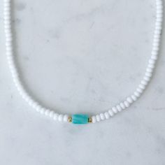 Dainty beaded choker necklace with a turquoise amazonite bar surrounded by small galvanized gold beads. Necklace is about 14 inches with a 2 inch extender. Cheap Turquoise Necklace With Tiny Beads, Adjustable Turquoise Beaded Amazonite Necklaces, Adjustable Single Strand Heishi Beads Jewelry, Adjustable Turquoise Beaded Chain Choker, Adjustable Single Strand Amazonite Beaded Necklace, Adjustable Turquoise Dainty Choker, Dainty Turquoise Adjustable Choker, Gold Single Strand Amazonite Beaded Necklace, Gold Single Strand Beaded Necklace With Amazonite