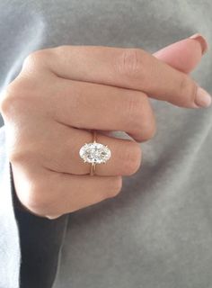 a woman's hand with a diamond ring on it