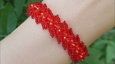 a red beaded bracelet on someone's arm