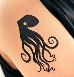 an octopus tattoo on the back of a woman's left arm, which is black and white