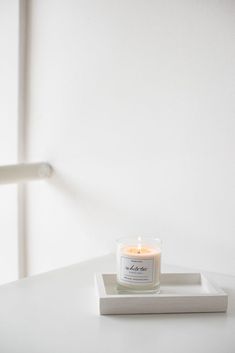 a candle sitting on top of a white tray