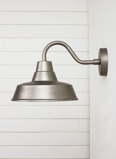 an industrial style wall light on the side of a building