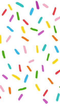 multicolored sprinkles are flying in the air on a white background