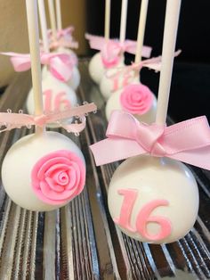 cake pops decorated with pink and white frosting