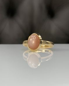 Natural Peach MoonStone * Dainty Cabachon Ring * Genuine MoonStone & 14K Solid Gold * Best Gift for her * Handmade Ring ◎ Details ◎ ○ Gemstone Details .Natural PEACH MOONSTONE Oval Cut 9X7 mm ○ Gold Details 14K Solid Gold Width of Band : 3.00 mm Weight of Ring : approx 4.60 gr Made to Order HANDMADE ITEM ○ Upgrade to Solid 18K Gold, please click the link below: https://www.etsy.com/listing/962826004 For more CABACHON BEZEL rings : http://etsy.me/37fvI60 All of our jewelleries are designed, c Elegant Domed Moonstone Gemstone Ring, Elegant Sunstone Jewelry, Round Shape, Classic Gold Moonstone Cabochon Ring, Classic Gold Moonstone Ring With Oval Cabochon, 14k Gold Moonstone Cabochon Ring For Anniversary, Elegant Untreated Moonstone Jewelry, Elegant Round Sunstone Jewelry, Elegant 14k Gold Cabochon Moonstone Ring, Elegant Oval Pink Opal Ring