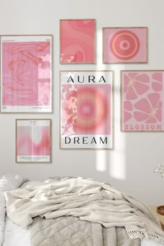 a bedroom with pink and white art on the wall