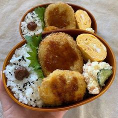 two bowls filled with rice, meat and veggies on top of each other