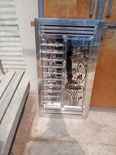 an open metal door on the side of a building next to concrete steps and stairs