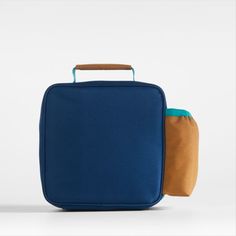 A fun and functional lunch box that's built to handle all the thrills and spills of the day. Combining colorblocks of navy and ocher with pops of aqua trim, our bag is constructed of food-safe and supremely durable polyester made from recycled water bottles. It's also lightweight and easy to clean, plus roomy enough to hold multiple storage containers. An insulated lining keeps meals just the way your kid likes them—hot, cold or somewhere in between. An outer pocket safely stows a napkin, utensi Blue Rectangular Lunch Box For Daily Use, Blue Rectangular Lunch Bag For Daily Use, Blue Functional Lunch Bag For Back To School, Functional Blue Rectangular Lunch Bag, Blue Functional Lunch Bag For Everyday Use, Functional Blue Lunch Bag For Everyday Use, Functional Blue Lunch Bag, Blue Lunch Bag For Back To School, Functional Blue Lunch Box For Everyday Use