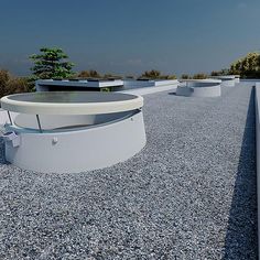 there are many round white tables on the top of this building with trees in the background