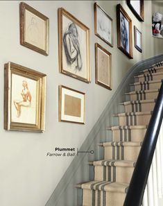 a staircase with pictures on the wall