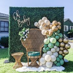 a chair with balloons on the grass next to a large sign that says happy birthday